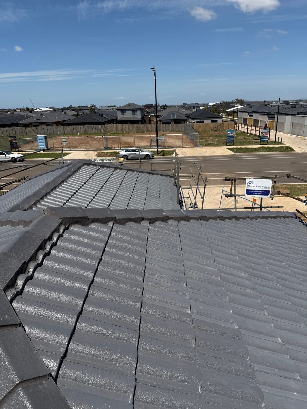 A street of new Melbourne homes with charcoal tile roofs