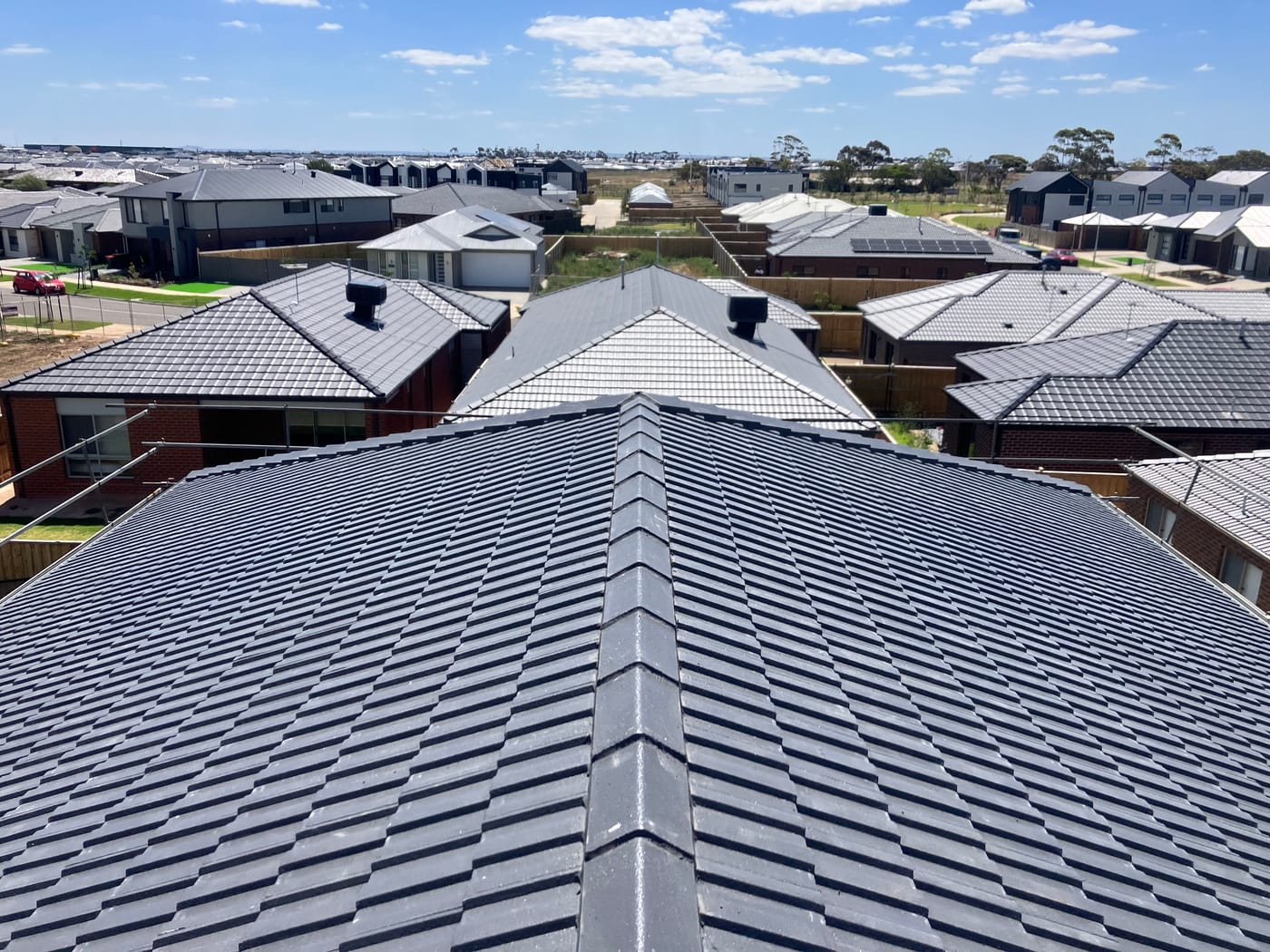 Roof valley and hips on a charcoal tile roof, sealed and watertight