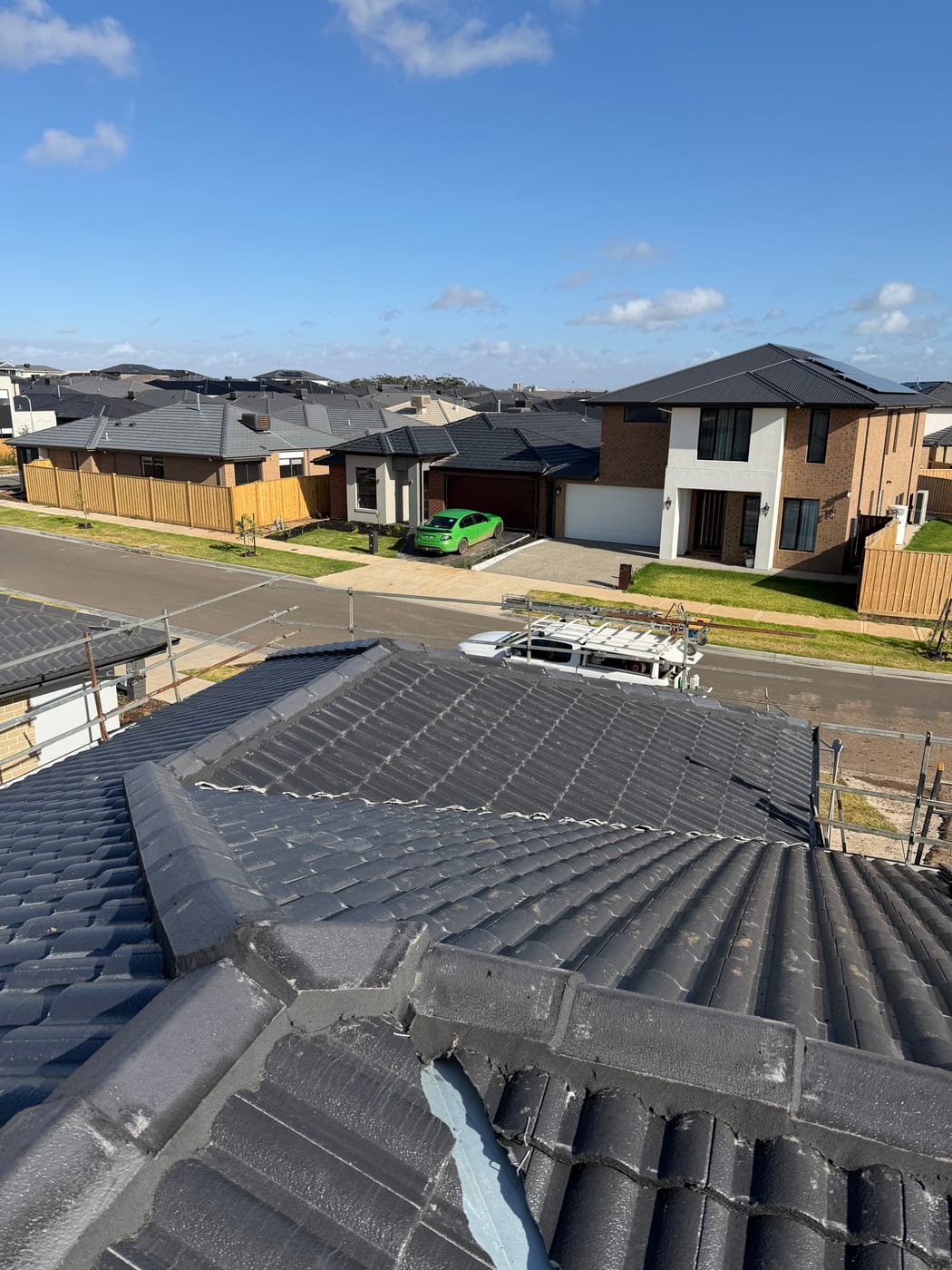A street of finished Melbourne homes with charcoal tile roofs