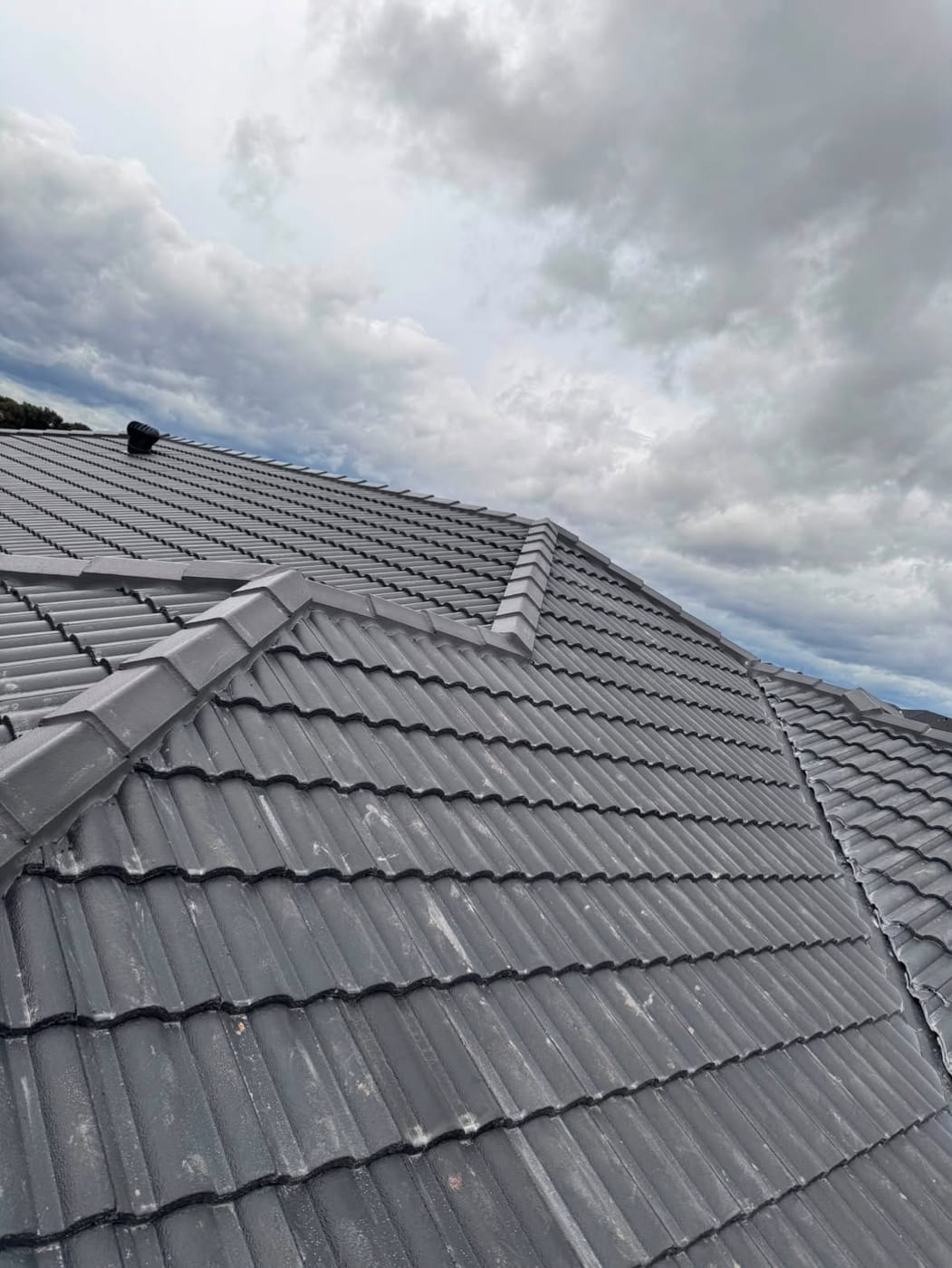 Hip and ridge detail on a charcoal tile roof