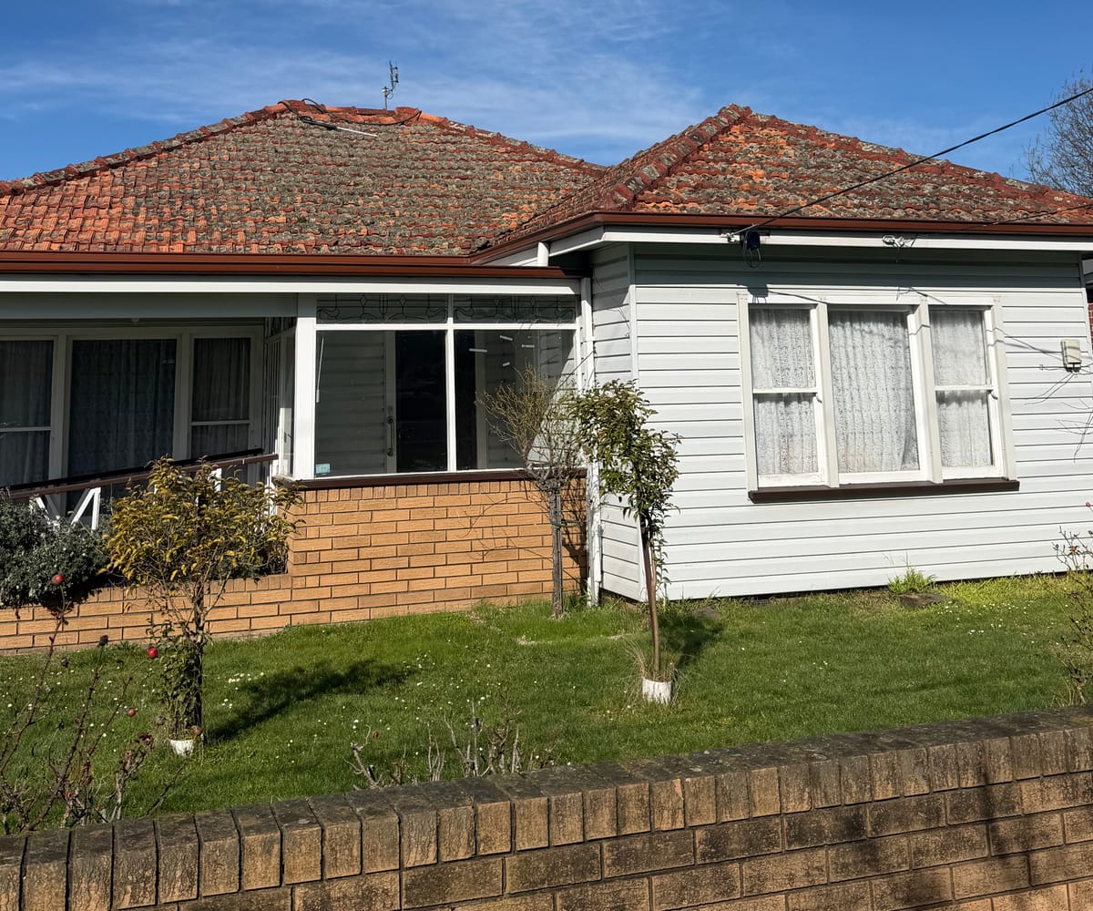 Tile roof covered in moss and lichen before a high-pressure clean by Wolfeden Roofing