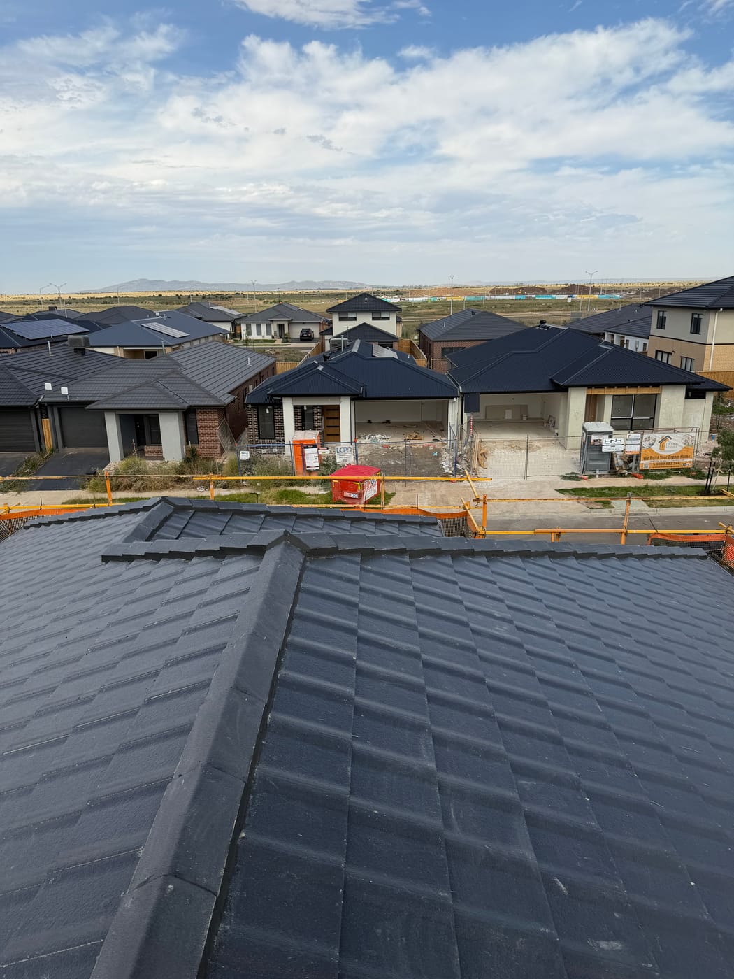 Re-pointed ridge capping on a charcoal tile roof by Wolfeden Roofing
