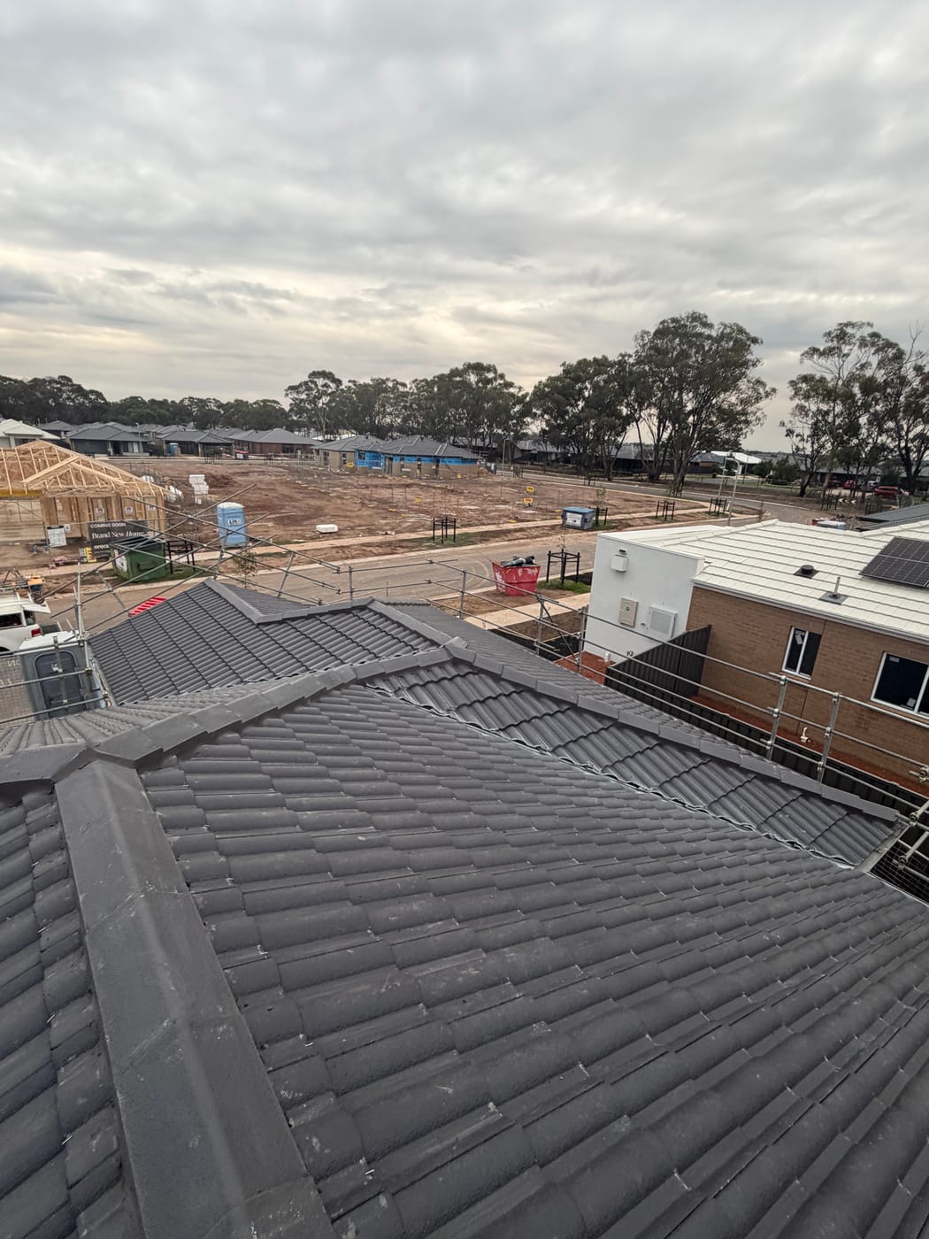 Aerial view of a freshly finished charcoal tile roof